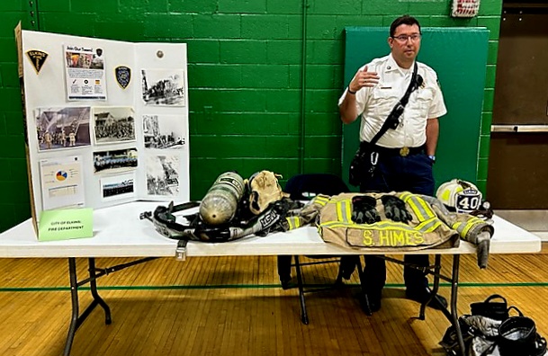 A photo of a fire chief showing his department's equipment